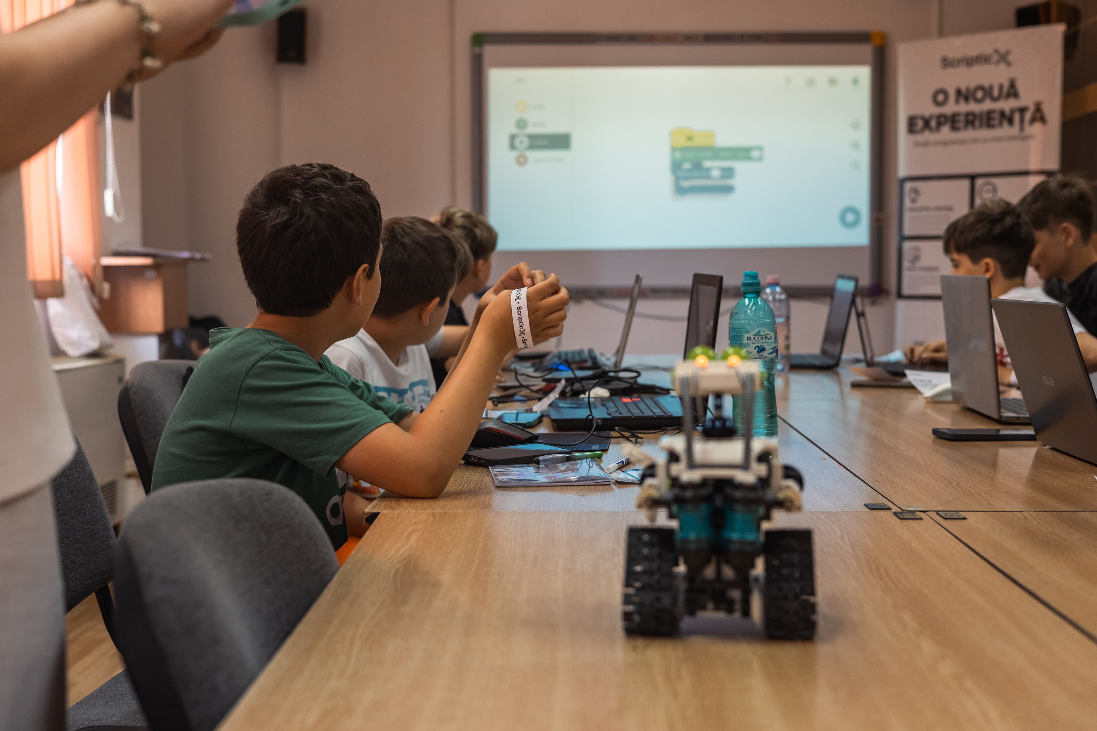 Children programming with a robot at a ScripticX workshop